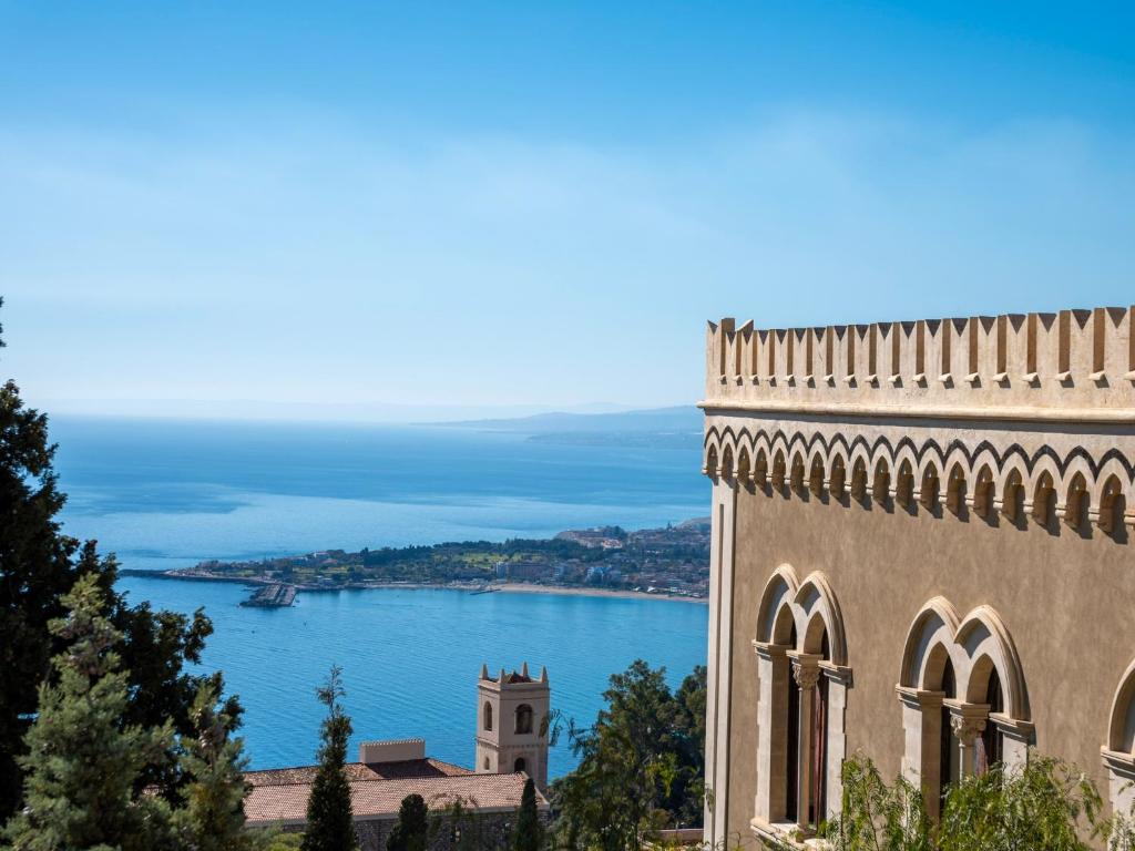 a building with a view of a body of water at Sea and the City in Taormina