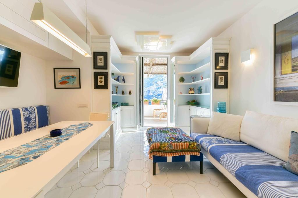 a living room with a couch and a table at Le Rocce da Tragara, Tragara essential in Capri