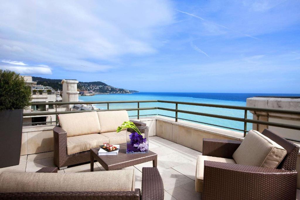 a balcony with chairs and a view of the ocean at Hyatt Regency Nice Palais de la Méditerranée in Nice