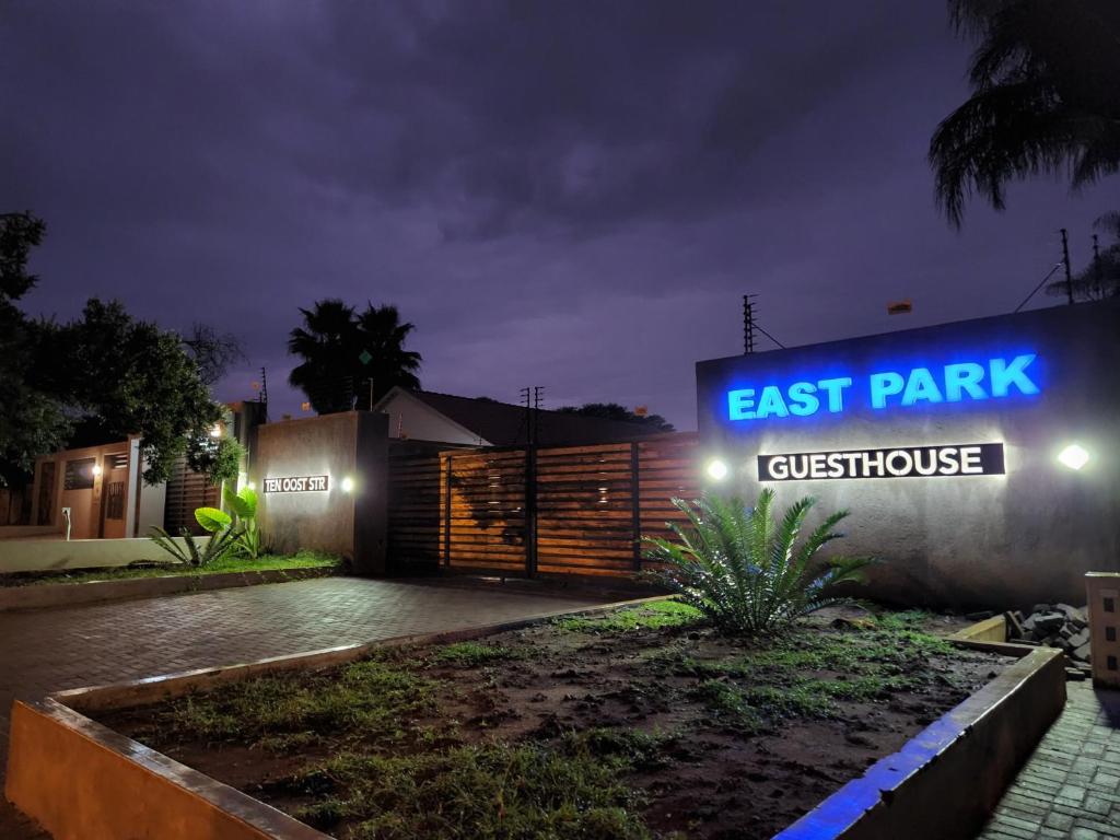 a sign that reads east park guesthouse at night at East Park Inn in Polokwane