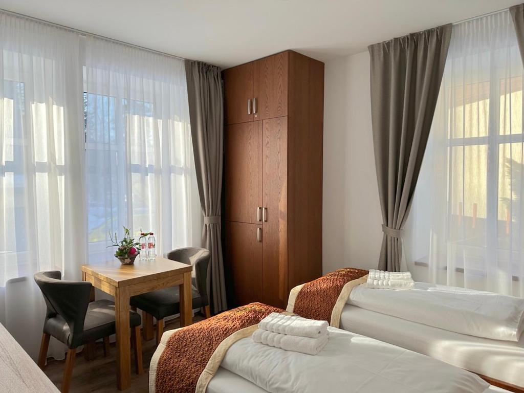 Postel nebo postele na pokoji v ubytování SYNEK Pension