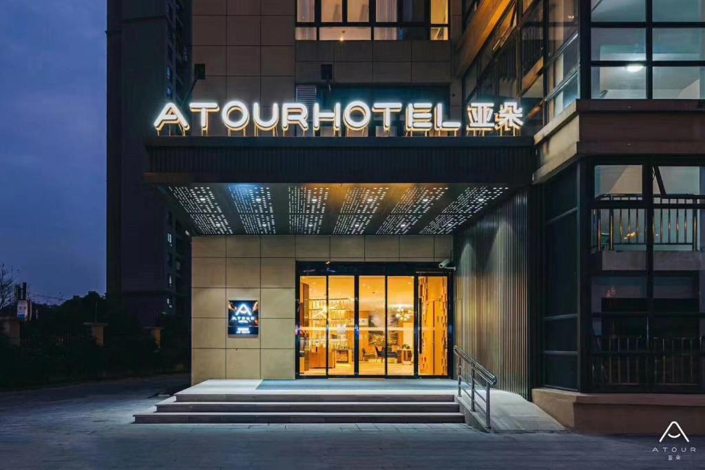 a hotel with a sign on the front of a building at Atour Hotel Jiading Jiangqiao Jiayi Road Subway Station in Fengbang