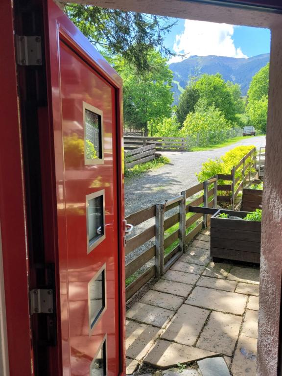 a red door with a view of a river at Apartment Peacock - Steinbock Lodges in Zell am See