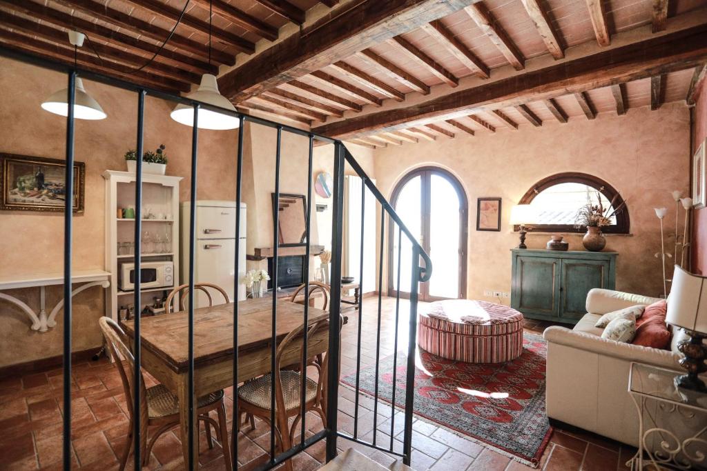 cocina y sala de estar con mesa en Appartamento La Roccaia, en San Gimignano