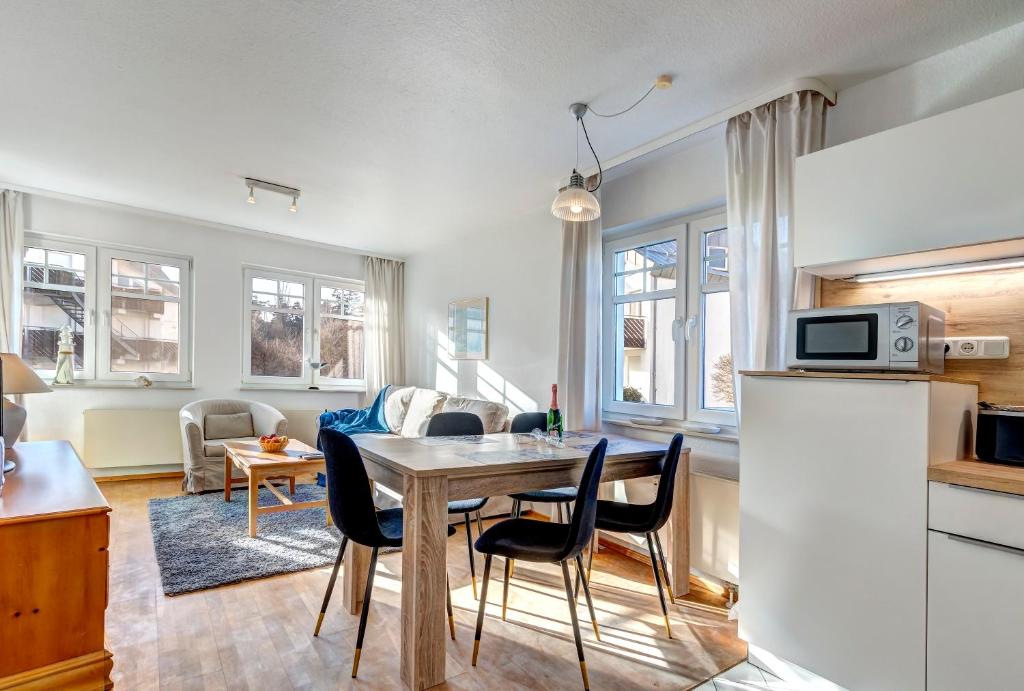 a kitchen and living room with a table and chairs at Seepark 705 in Bansin