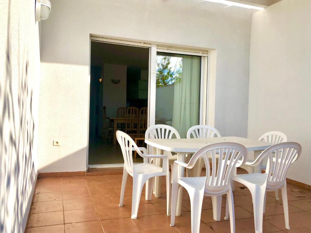 a white table and chairs on a patio at Duplex Ancla in L'Ametlla de Mar