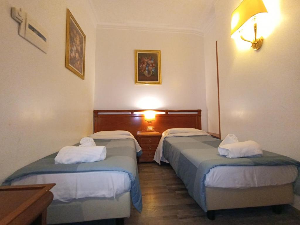 Postel nebo postele na pokoji v ubytování Hotel Positano