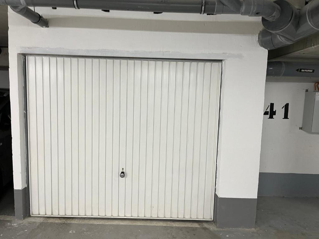 a large white garage door with a number four at Appartement de Romainville in Romainville