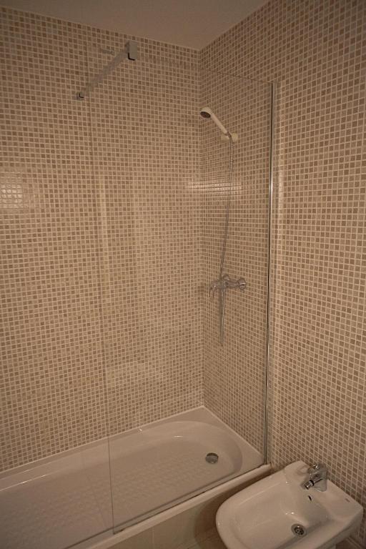 a bathroom with a shower and a toilet and a sink at Duplex Ancla in L'Ametlla de Mar