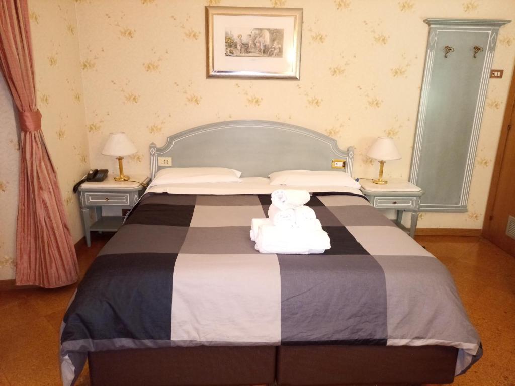 Postel nebo postele na pokoji v ubytování Hotel Positano