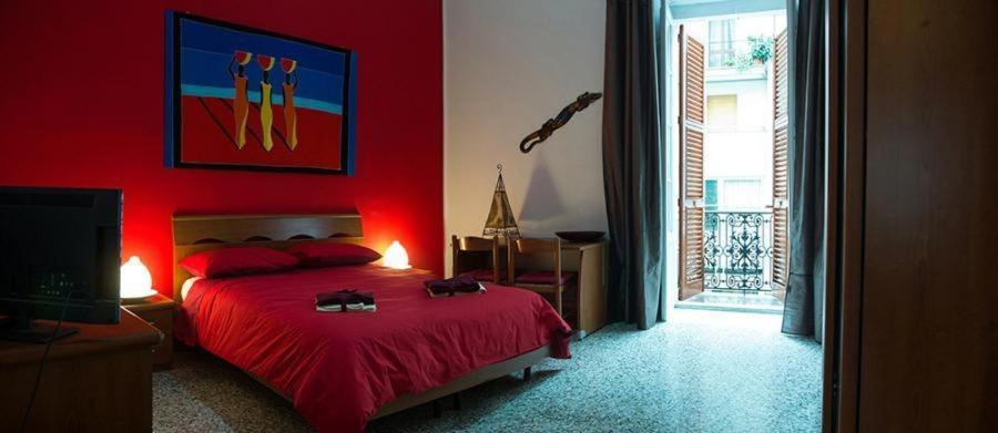 1 dormitorio rojo con 1 cama y pared roja en Portobello Appartamento 3 camere 3 bagni, en Taranto