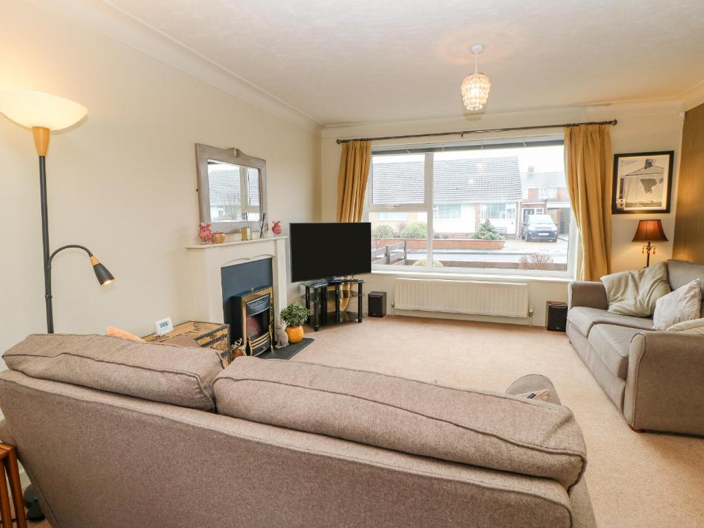 a living room with a couch and a tv at 8 Hampton Road in North Shields
