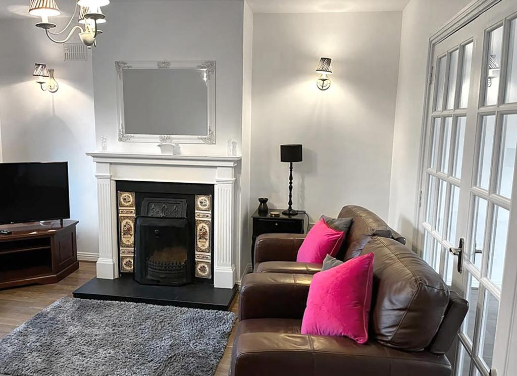 a living room with a couch and a fireplace at Burren Seaside Lodge in Ballyvaughan