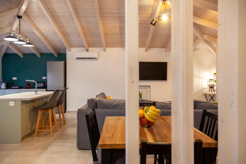 a living room and kitchen with a table and a couch at Kamari Luxury Apartment in Lefkada Town