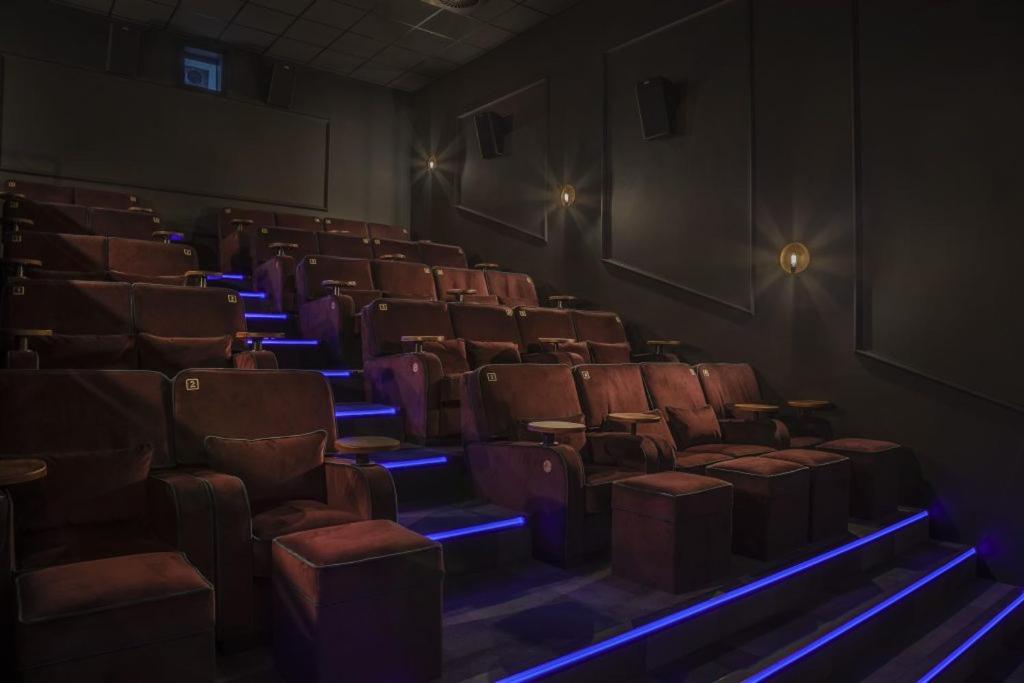 an empty auditorium with chairs and blue lights at The Woolacombe Bay Hotel in Woolacombe