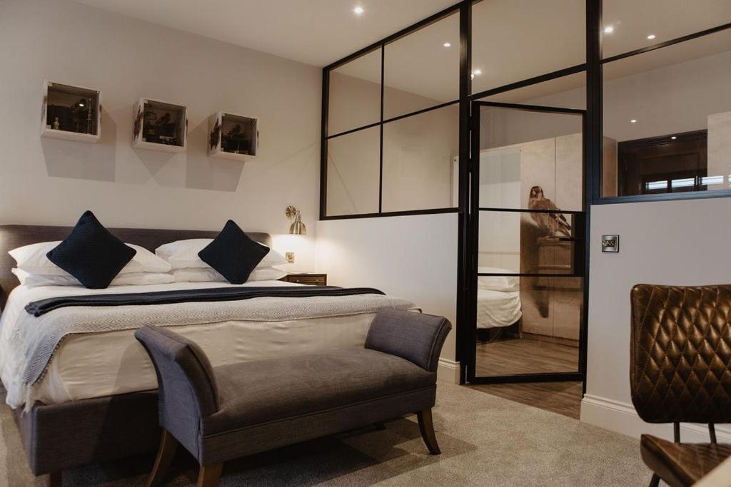 a bedroom with a large bed and a chair at The Woolacombe Bay Hotel in Woolacombe