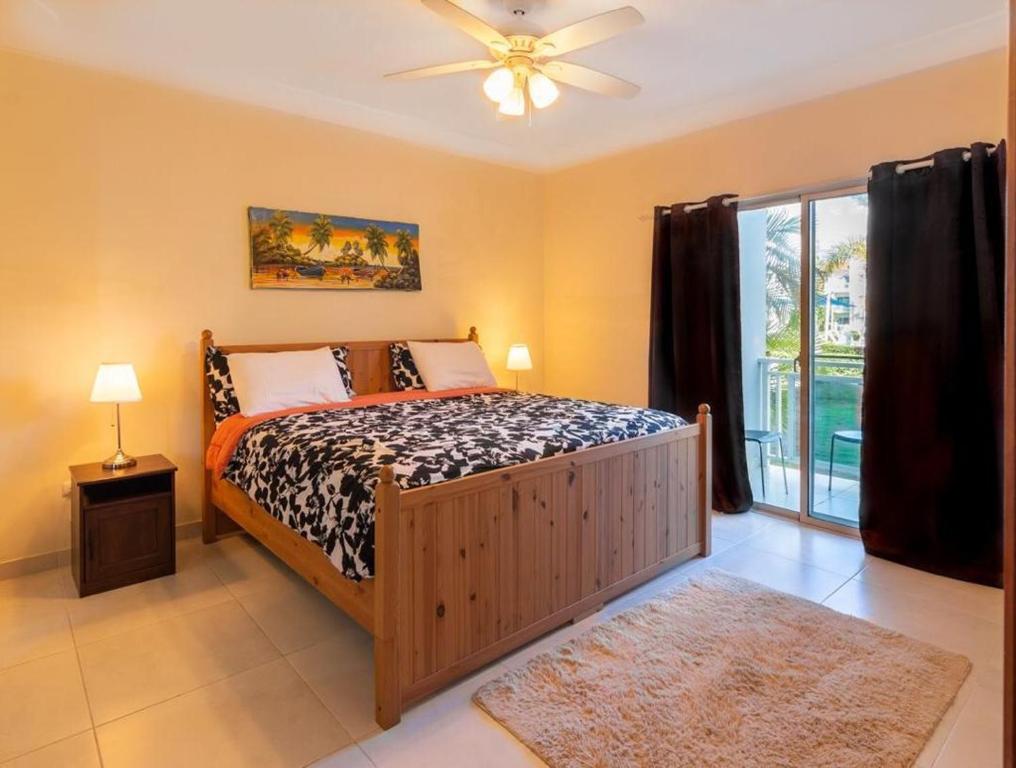a bedroom with a bed and a ceiling fan at Caribbean Treasure in Punta Cana