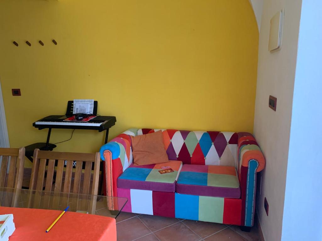 a living room with a colorful couch and a table at Villa Melissa in Diano Castello