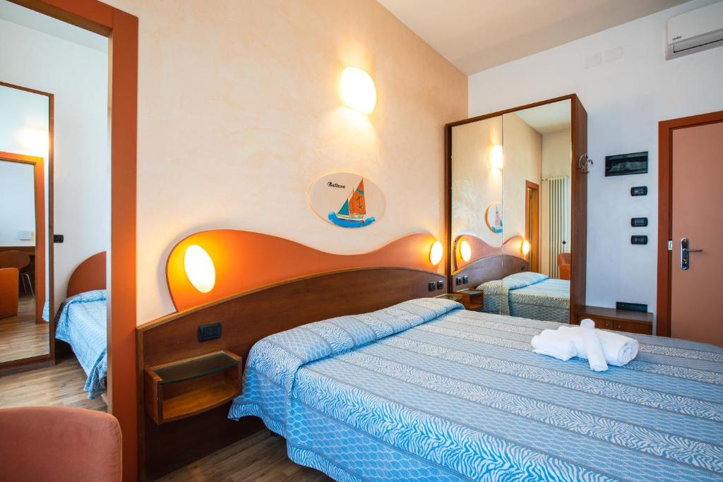 Postel nebo postele na pokoji v ubytování Miramare Hotel Ristorante Convegni