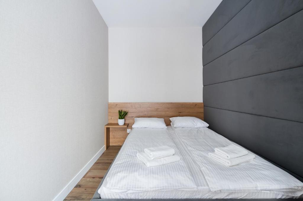 Posteľ alebo postele v izbe v ubytovaní Krakowiak Apartment