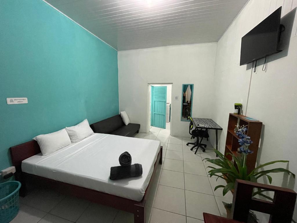 a bedroom with a bed and a television in it at Tourquesa Excellent WiFi Private in Liberia