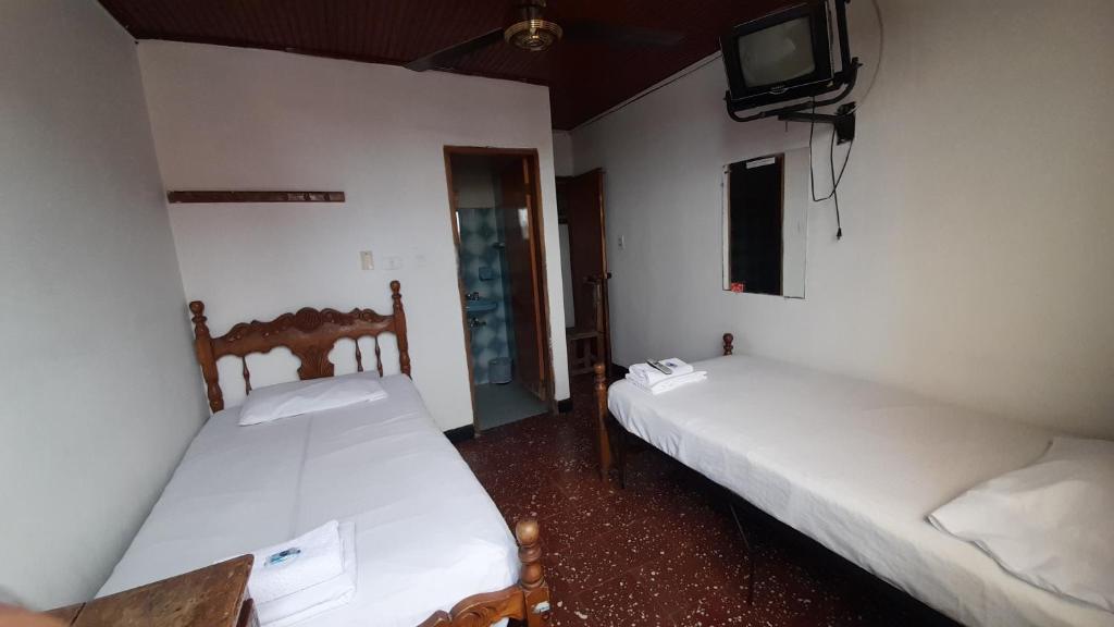 Postel nebo postele na pokoji v ubytování HOTEL en MONTERIA CITY