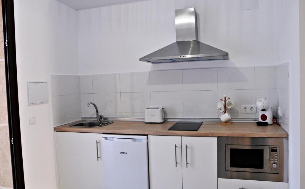 Kuchyň nebo kuchyňský kout v ubytování Apartamentos Turaca