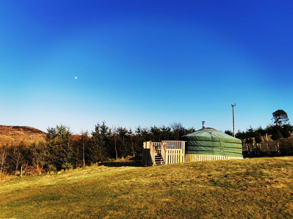 a large green dome building on a grassy hill at The Yurt in Newton Stewart