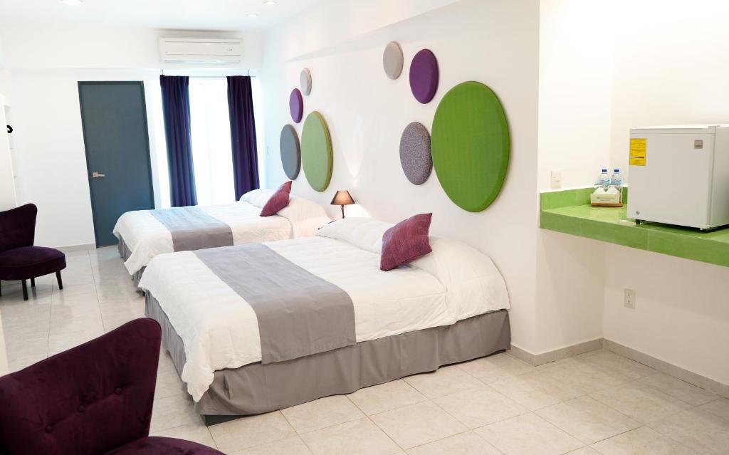 Postel nebo postele na pokoji v ubytování TRYP by Wyndham Chetumal