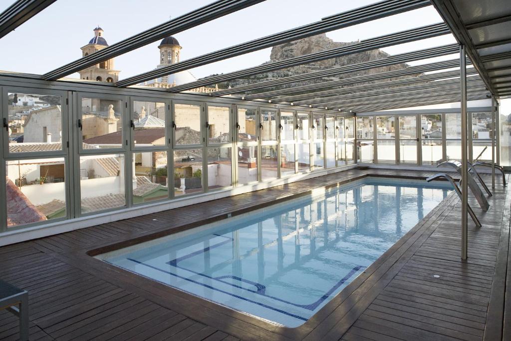 a swimming pool on the roof of a building at Hospes Amérigo in Alicante