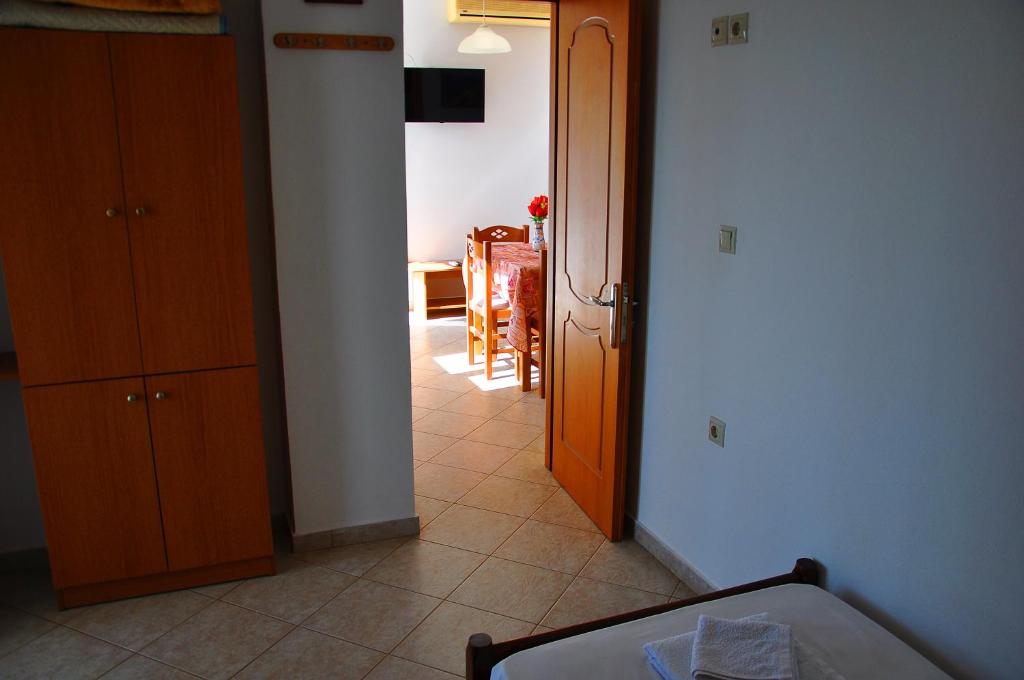 a room with a hallway with a table and a door at Lagos Studios & Apartments in Palekastron