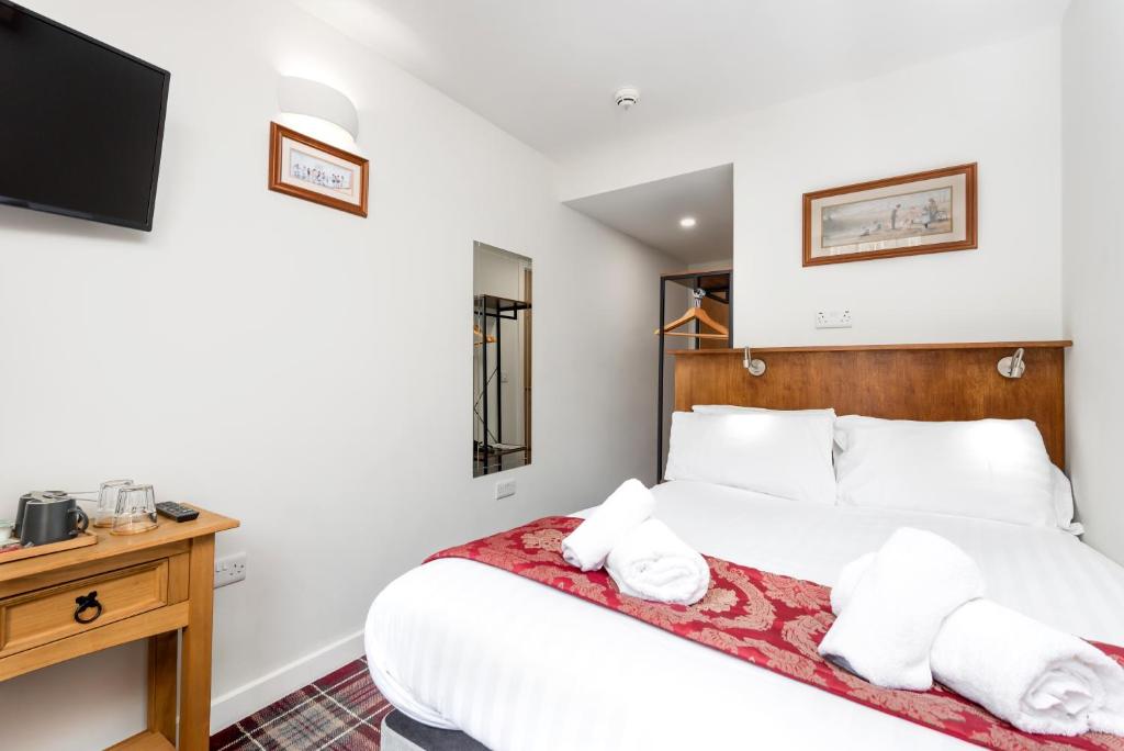 Postel nebo postele na pokoji v ubytování SMITH PLACE HOTEL