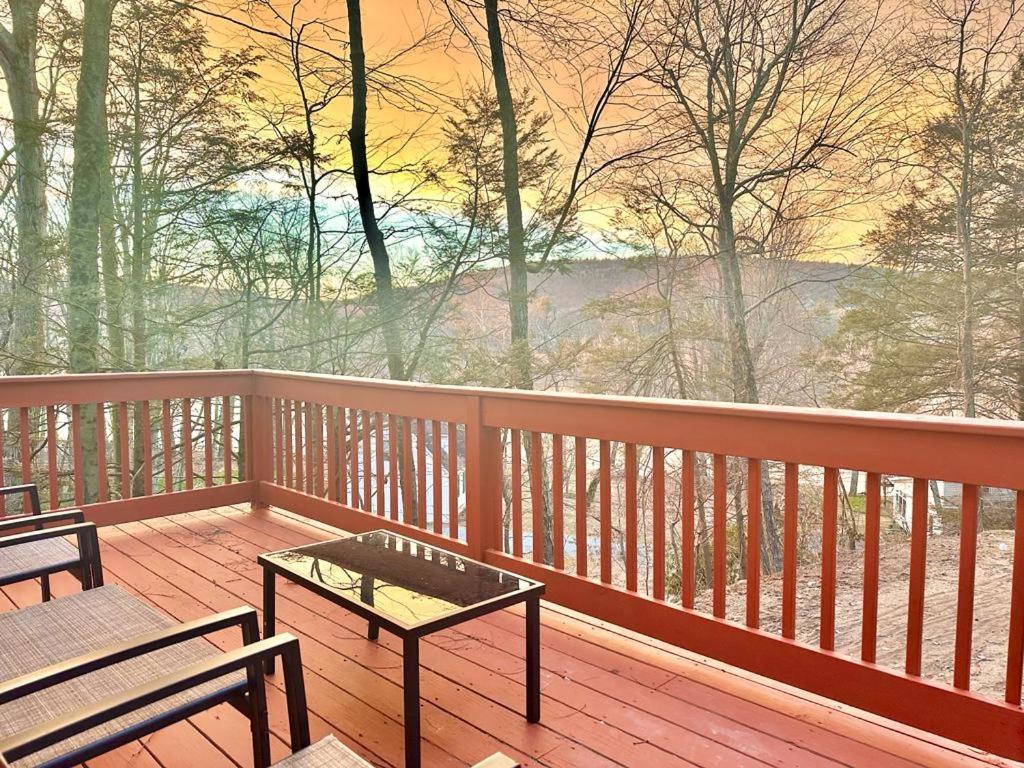a deck with two benches and a table on it at Chic Chalet River Views & Access 