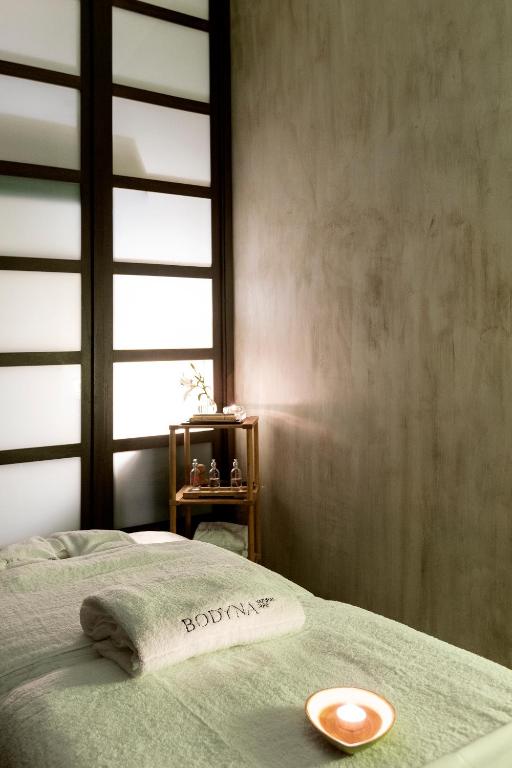 a bedroom with a bed with a towel on it at Hospes Palacio del Bailio, a Member of Design Hotels in Córdoba