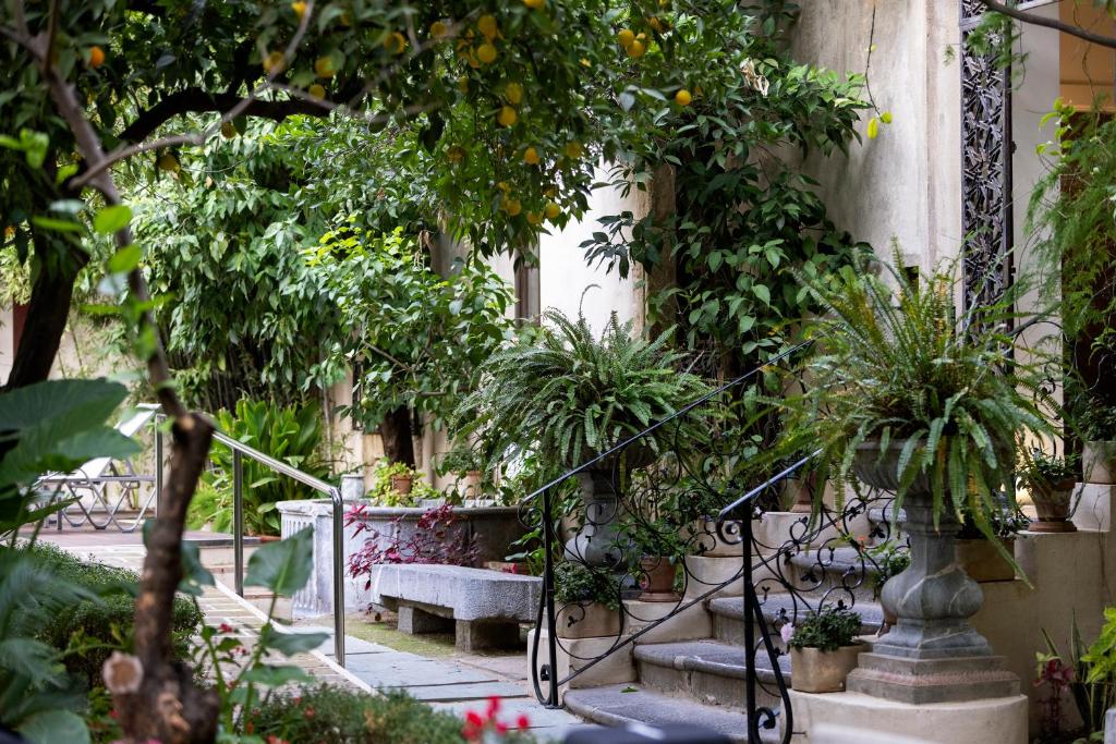 a garden with a bunch of trees and plants at Hospes Palacio del Bailio, a Member of Design Hotels in Córdoba
