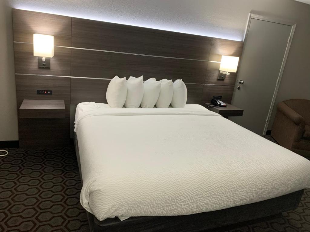 duże białe łóżko w pokoju hotelowym w obiekcie Days Inn by Wyndham Wagoner w mieście Wagoner