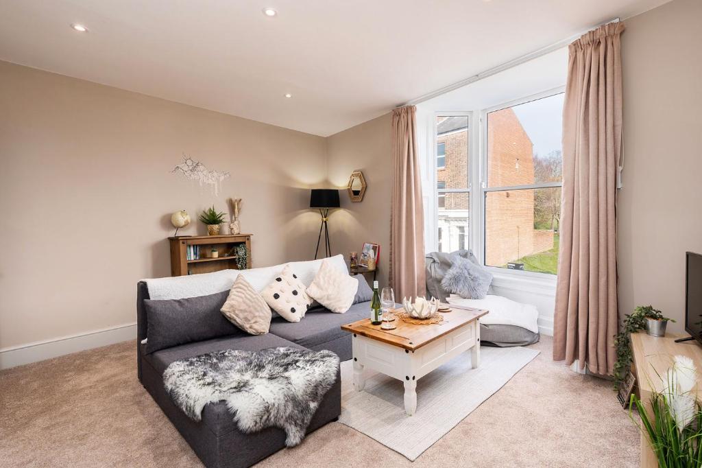 a living room with a couch and a table at The Cosy Norse Retreat in York