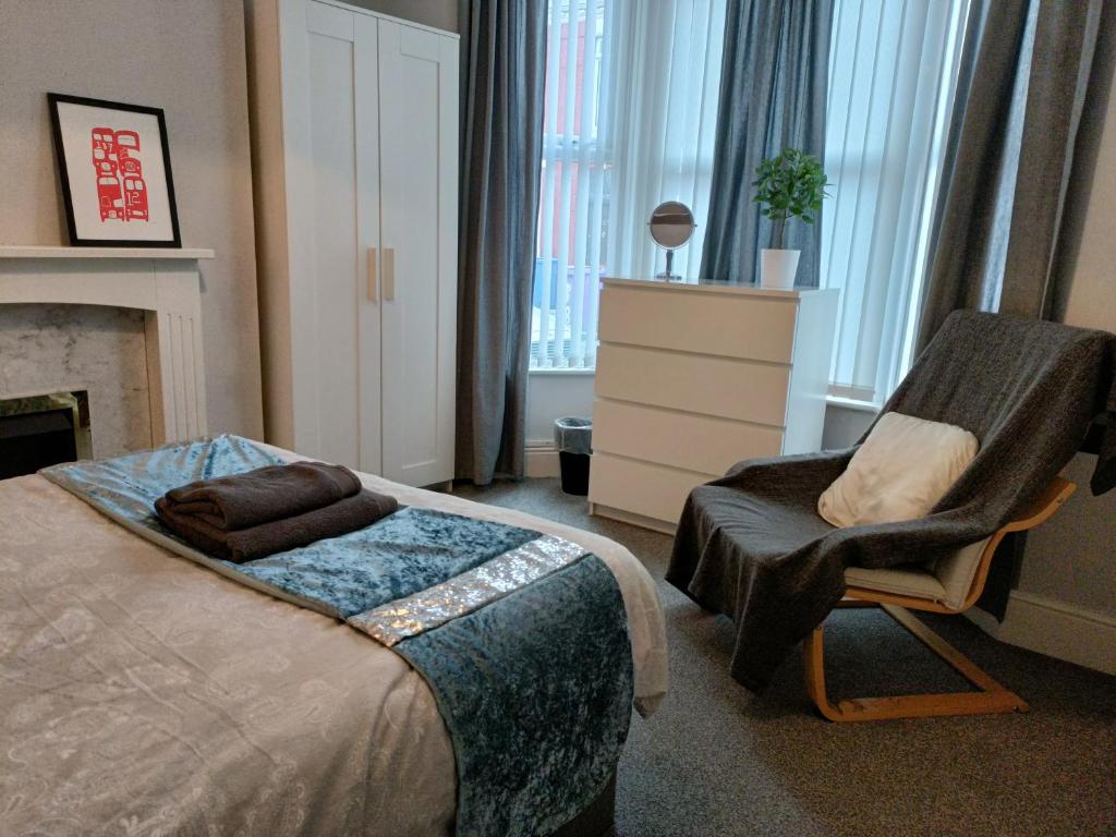 a bedroom with a bed and a chair at Talton House in Liverpool