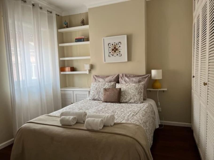 een slaapkamer met een bed met twee handdoeken erop bij NEW Cosy & Charming Apartment in Campolide - 3A in Lissabon