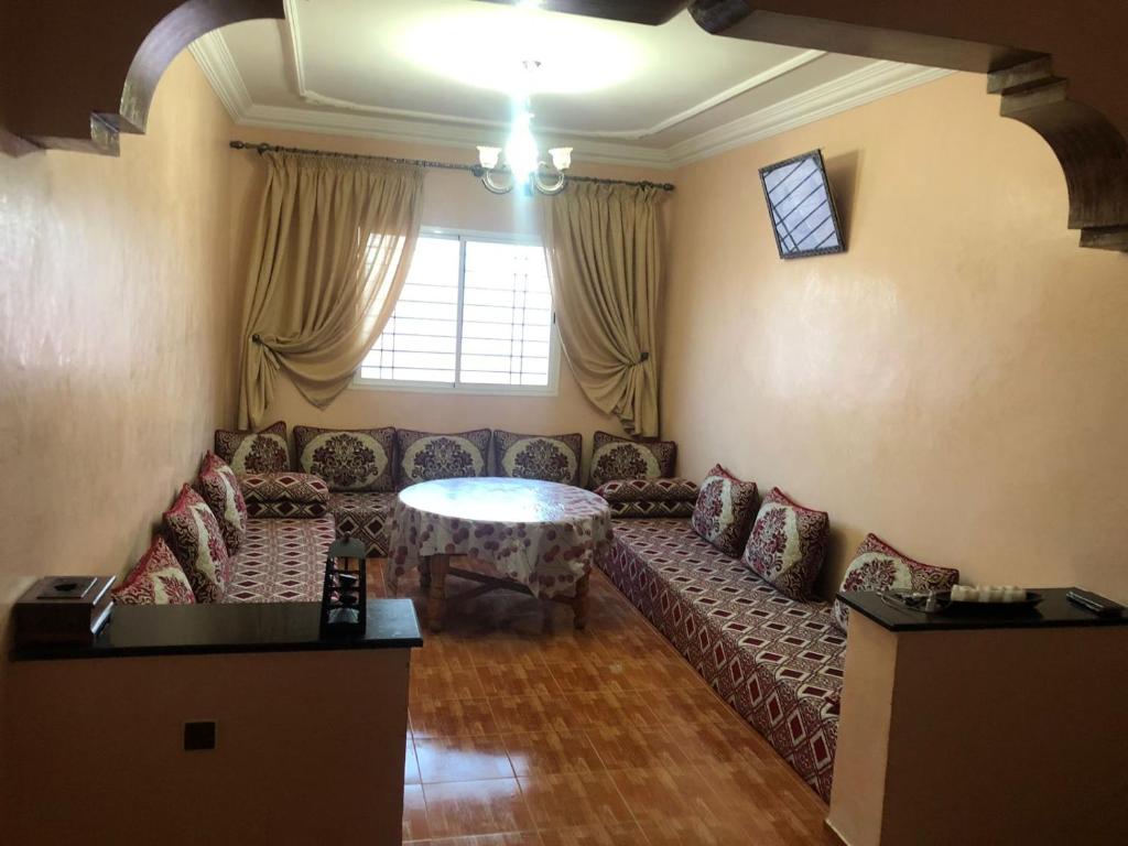 a living room with a couch and a table at HILAL in Sidi Bouzid