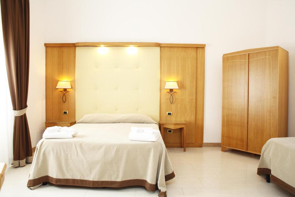Posteľ alebo postele v izbe v ubytovaní Albergo Russo