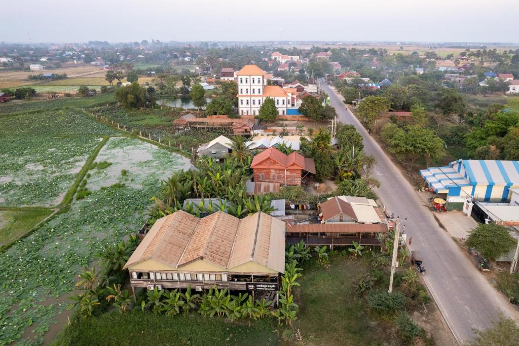 an aerial view of a village with a house and a road at Damnak Phnom Krom Homestay in Phumĭ Rœssei Lŭk