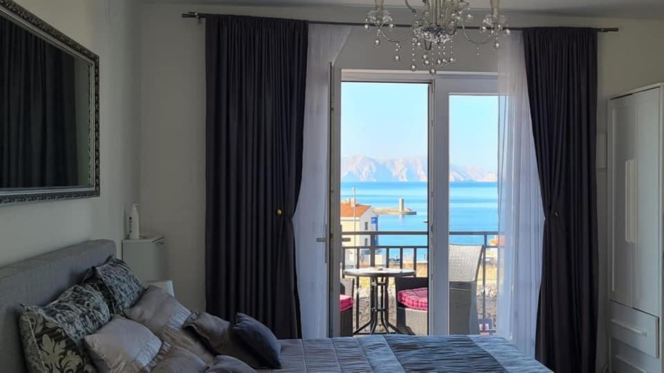 a bedroom with a bed and a view of the ocean at Beautyful sea view 6 luxury studio Danijela 1 in Senj
