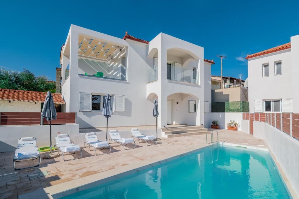 a villa with a swimming pool and a house at Astarte Villas - Coral Bleu Villa with Private Pool in Tsilivi