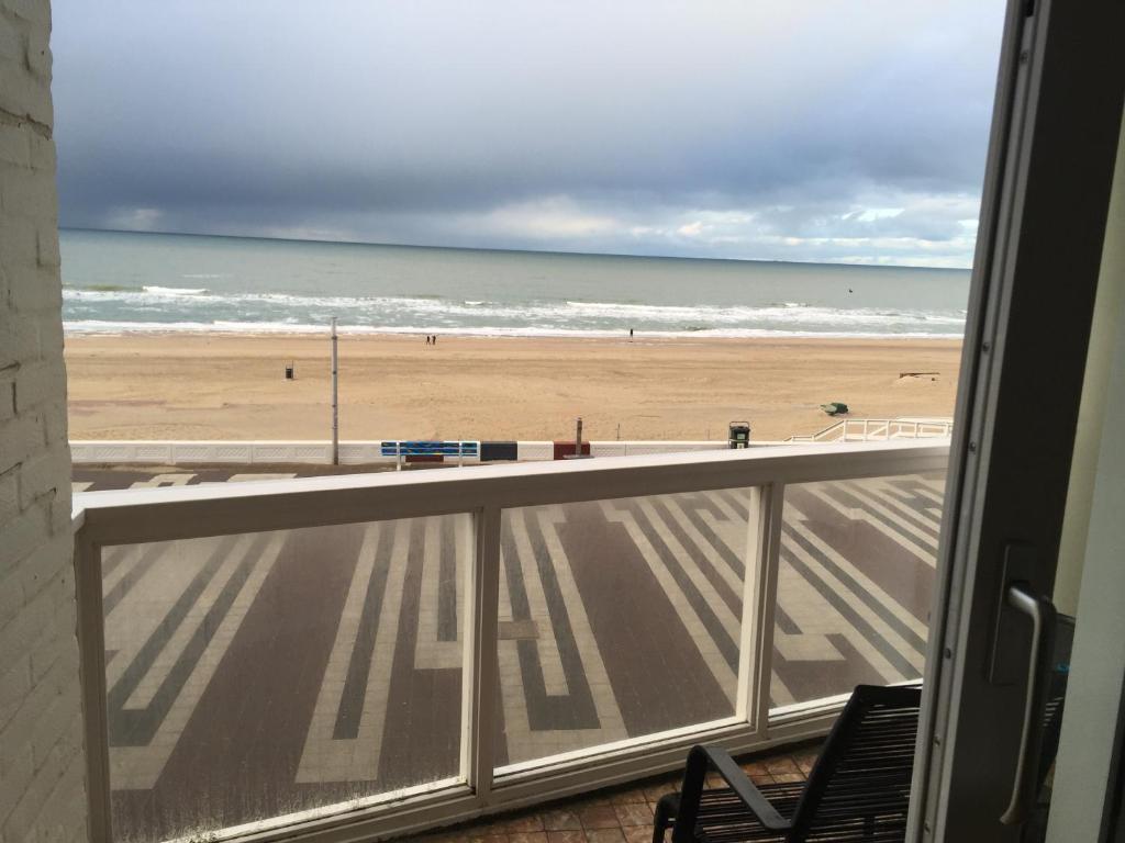 a view of the beach from a balcony at Beach Apartments Seaview Plus Parking in Zandvoort