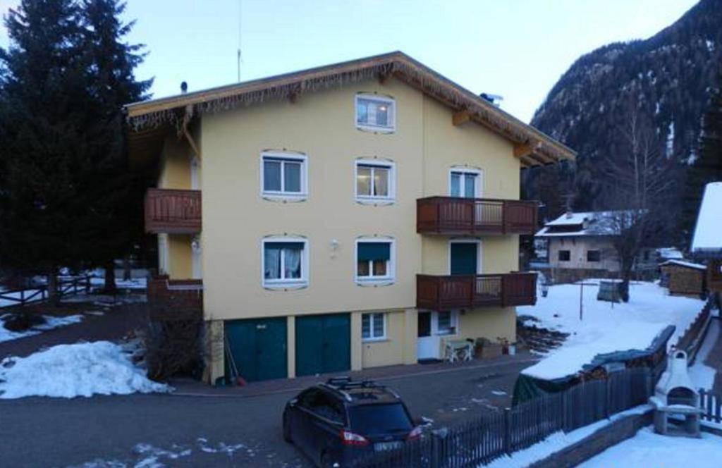 a house with a car parked in front of it at Casa Brugnara in Pozza di Fassa