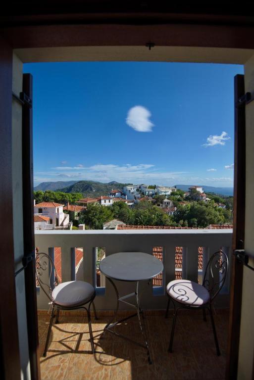 a balcony with a table and chairs and a view at Anatoli Residences in Alonnisos