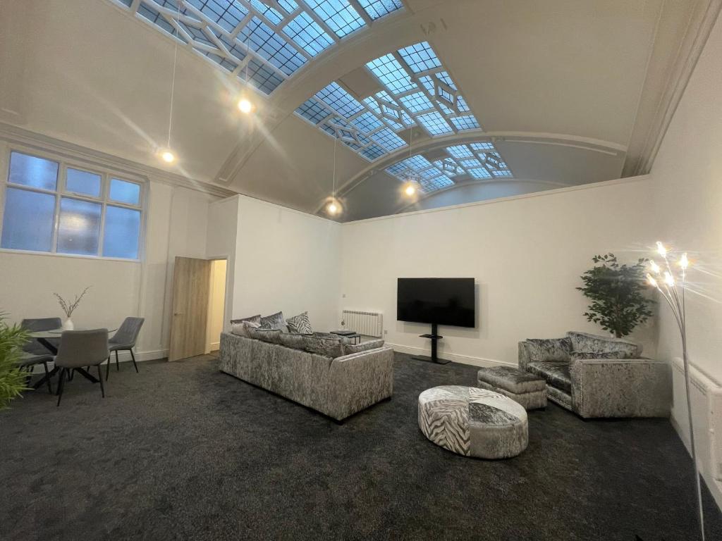 a large living room with a skylight and a television at #20 Grimston St 2 bedroom apartment near Hull New Theatre in Hull