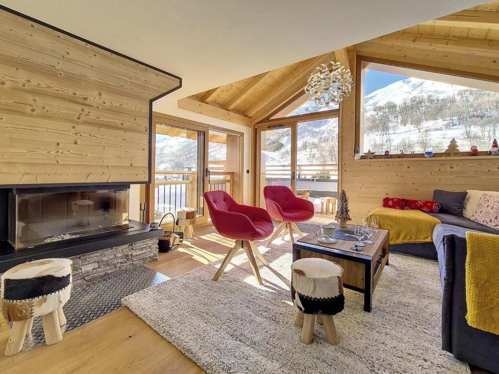 a living room with a couch and a fireplace at Chalet Saint-Martin-de-Belleville-Les Menuires, 5 pièces, 10 personnes - FR-1-344-1160 in Praranger