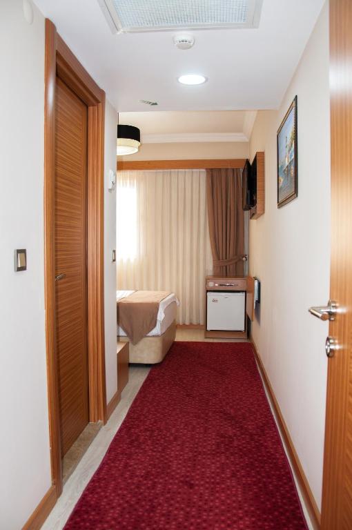 A bed or beds in a room at Quars Garden Hotel